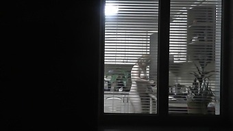 A Voyeuristic Neighbor Observes A Naked Woman Cooking For Her Husband Through An Open Window